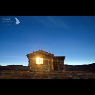 Shooting star above mountain hut